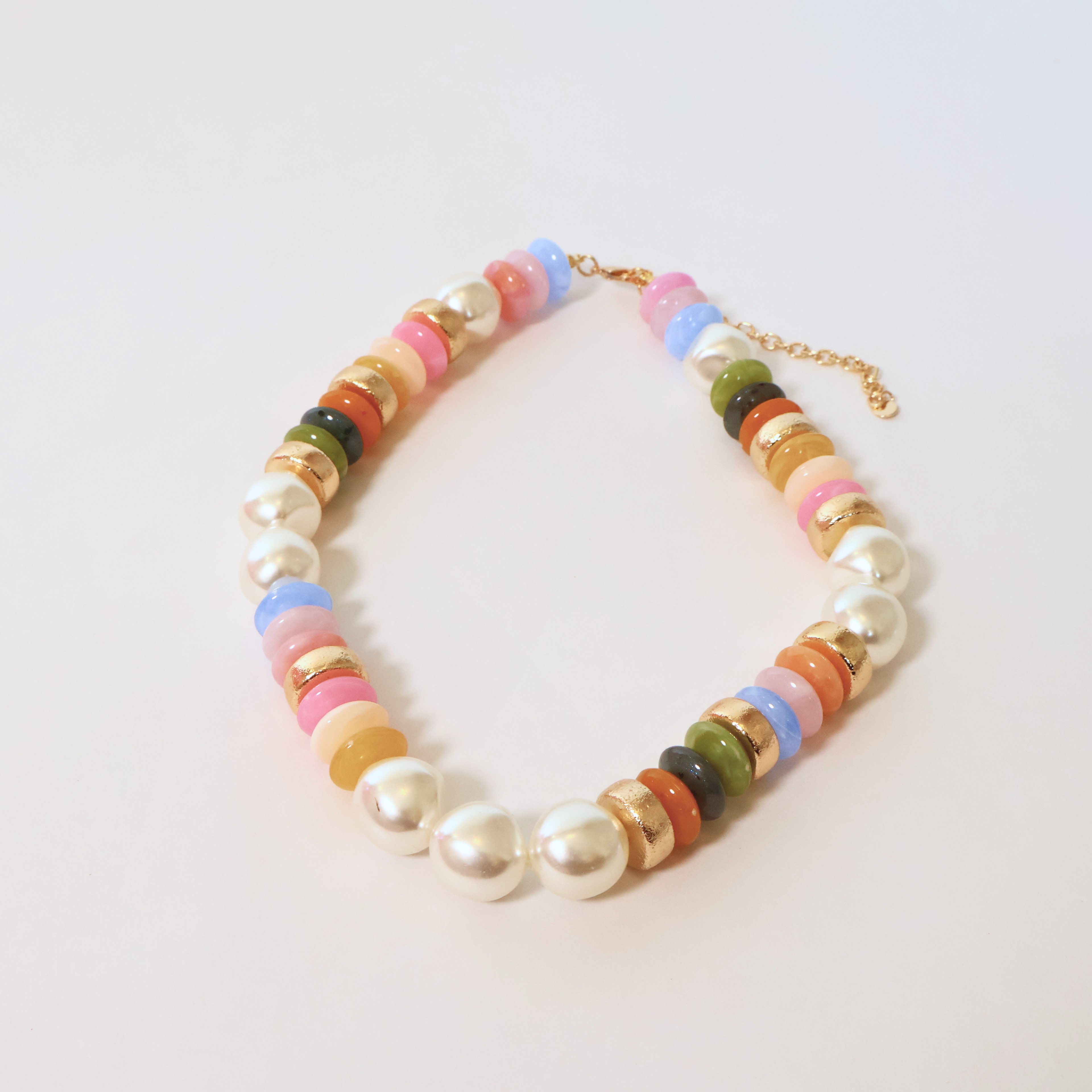 Mixed beaded necklace on a white background