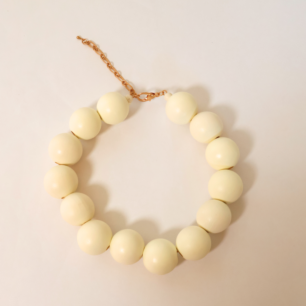 cream Wooden beaded necklace on white background