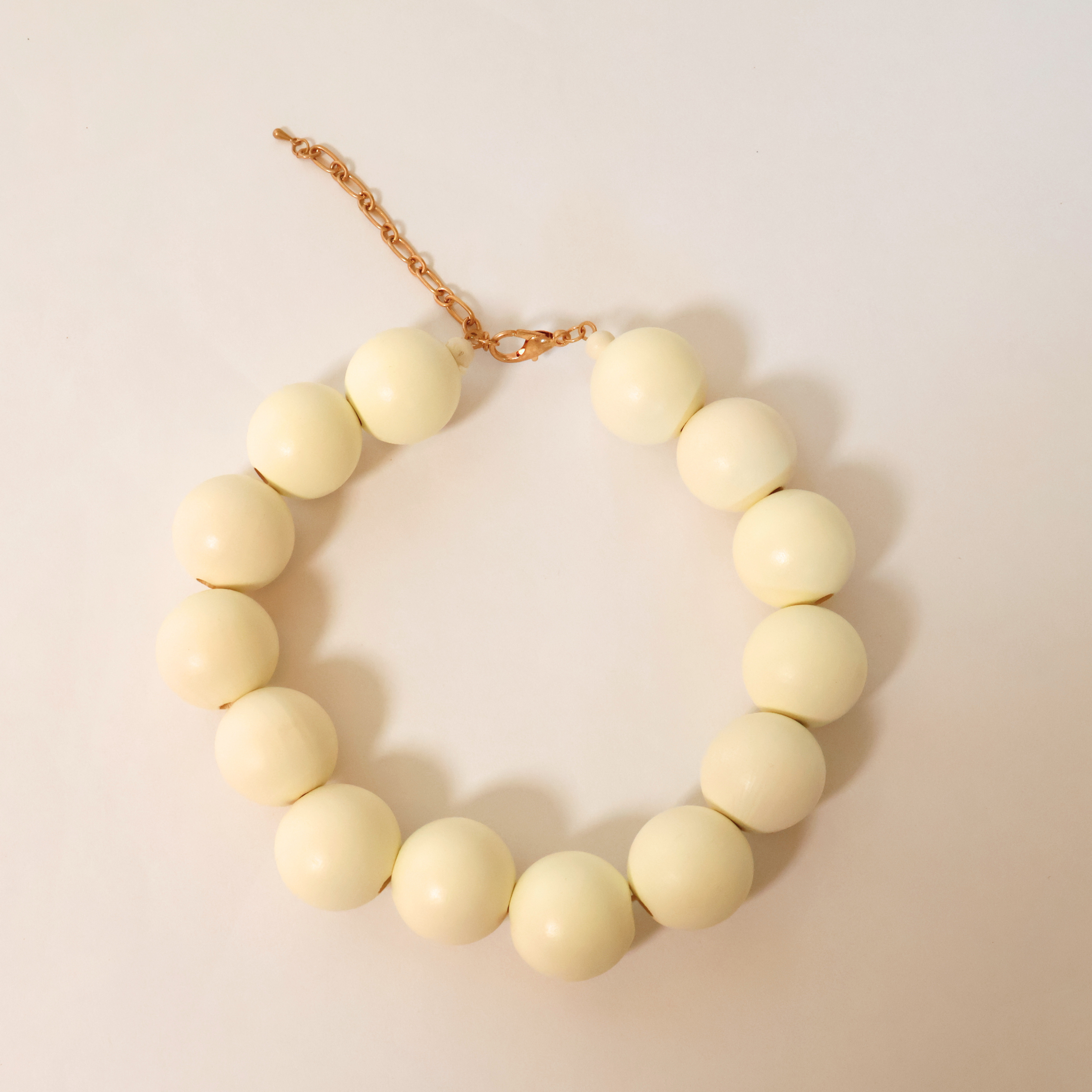 cream Wooden beaded necklace on white background