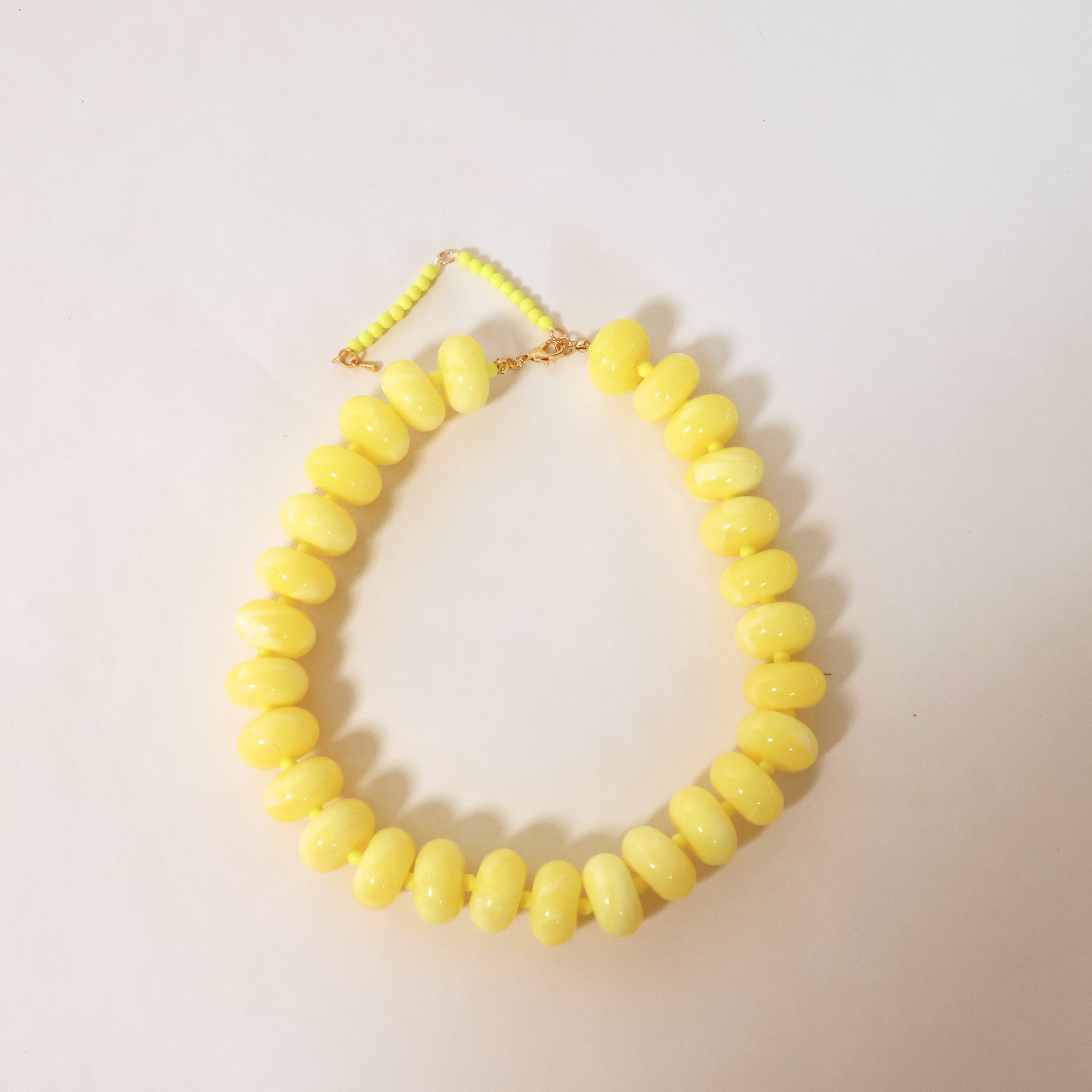 yellow necklace on a white background