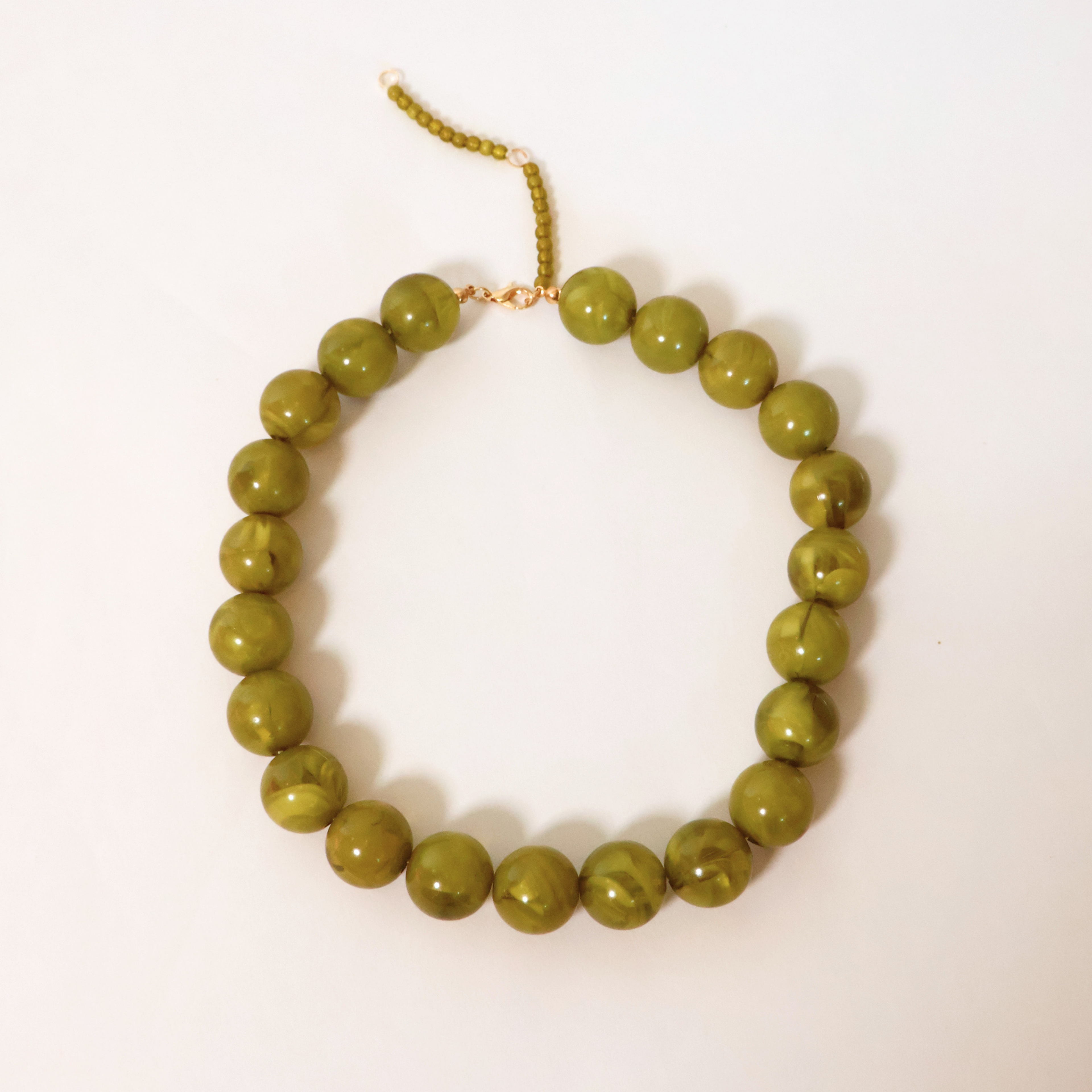 green Kameron beaded necklace on a white background