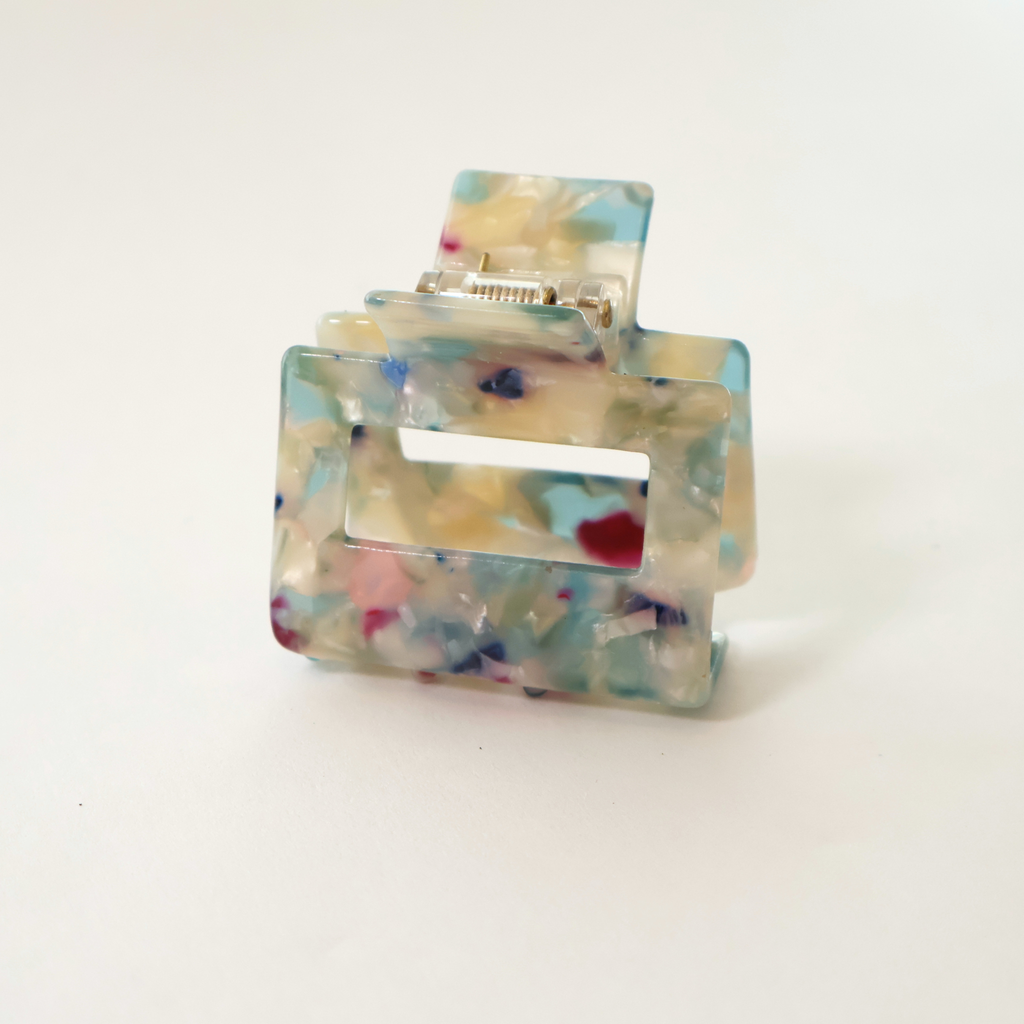 Blue multi colored marbled claw clip on white background