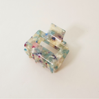 side view Blue multi colored marbled claw clip on white background
