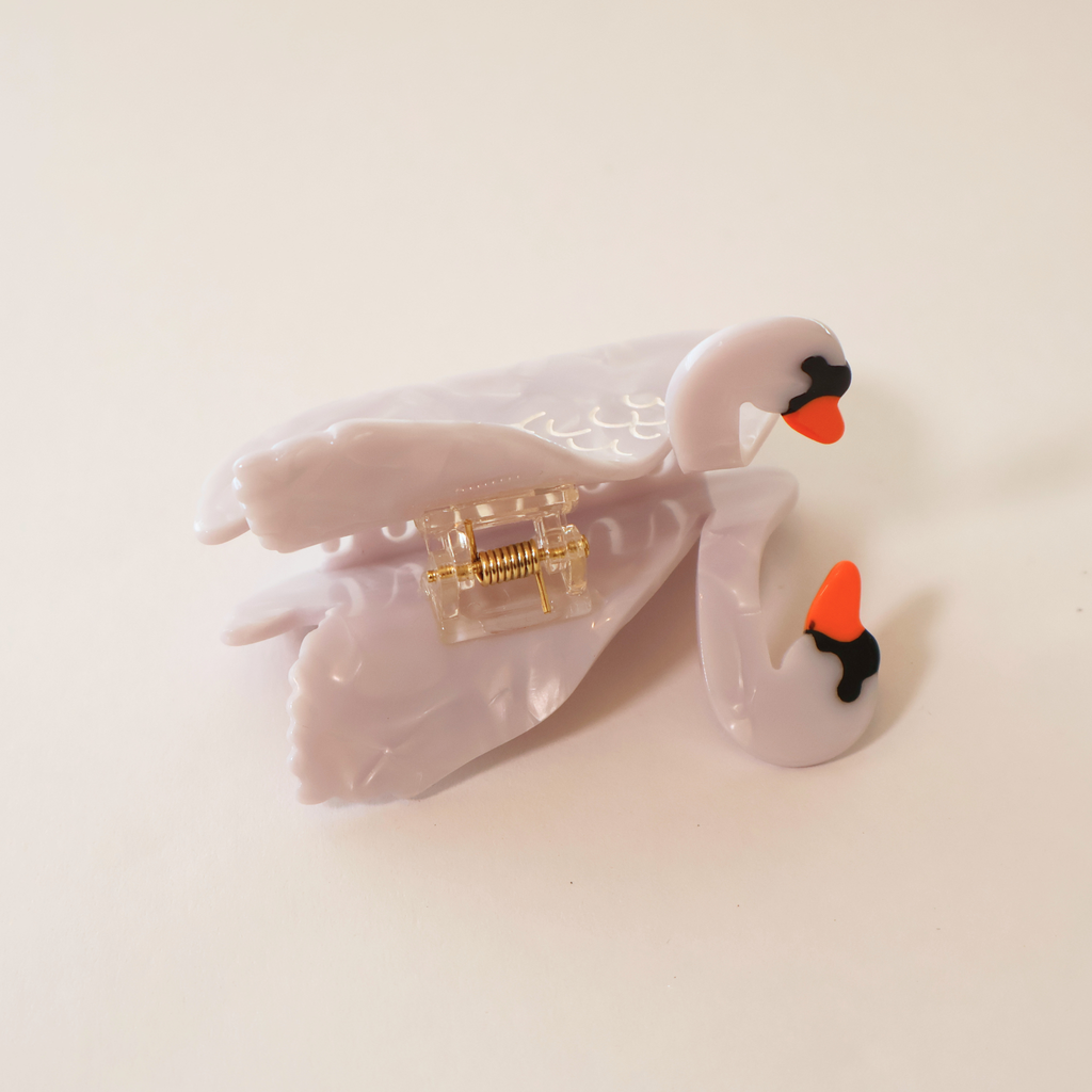 top view of swan claw clip laid on its side on a white backdrop