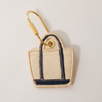 Navy Blue bag shaped bag charm on a white background