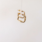 side view of earrings to show shape. displayed on a white background.