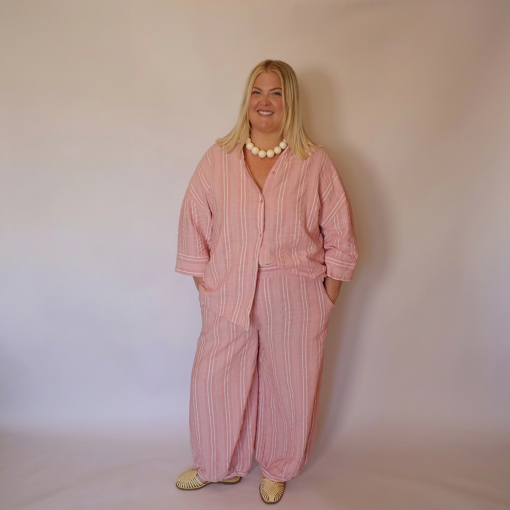 Woman facing forward wearing the matching Azalea button down shirt and balloon style pants. 