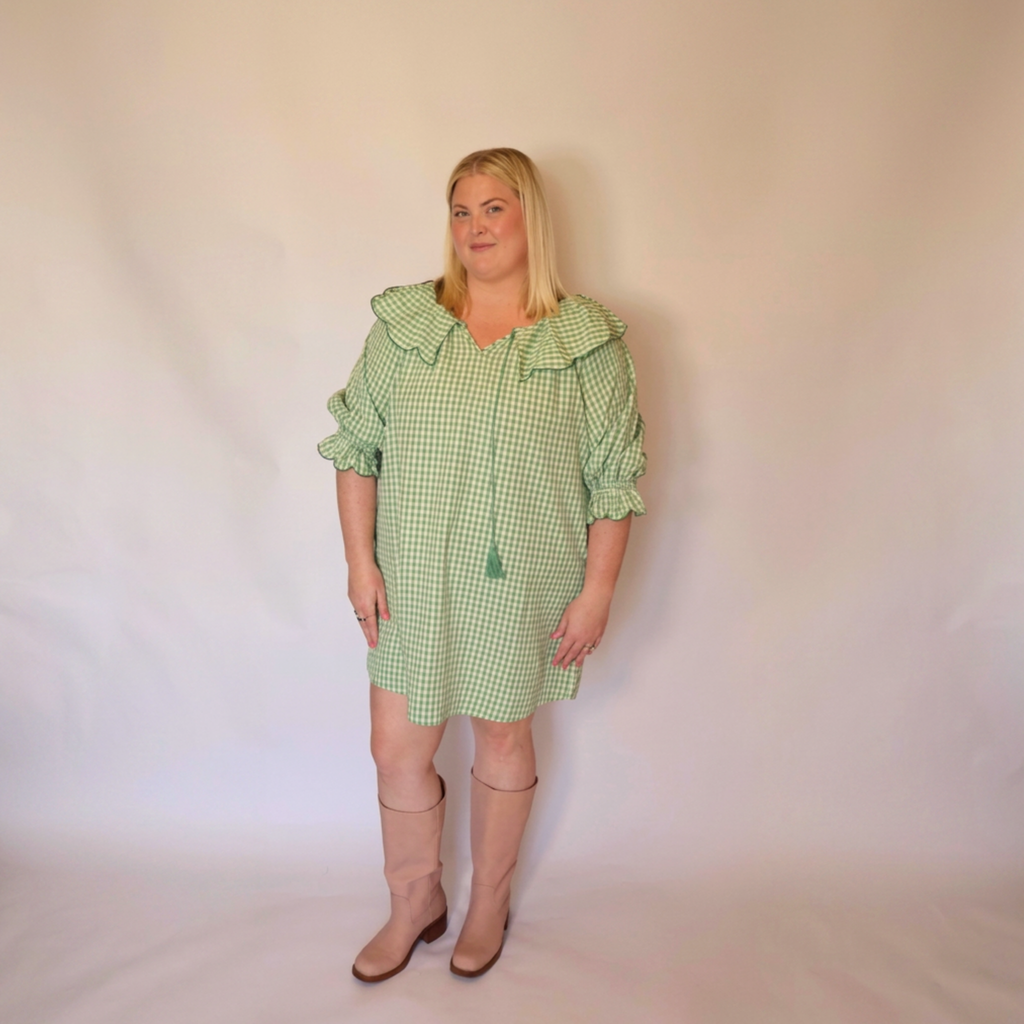 Woman facing forward wearing the Green Gingham Louisa Dress and pink boots.