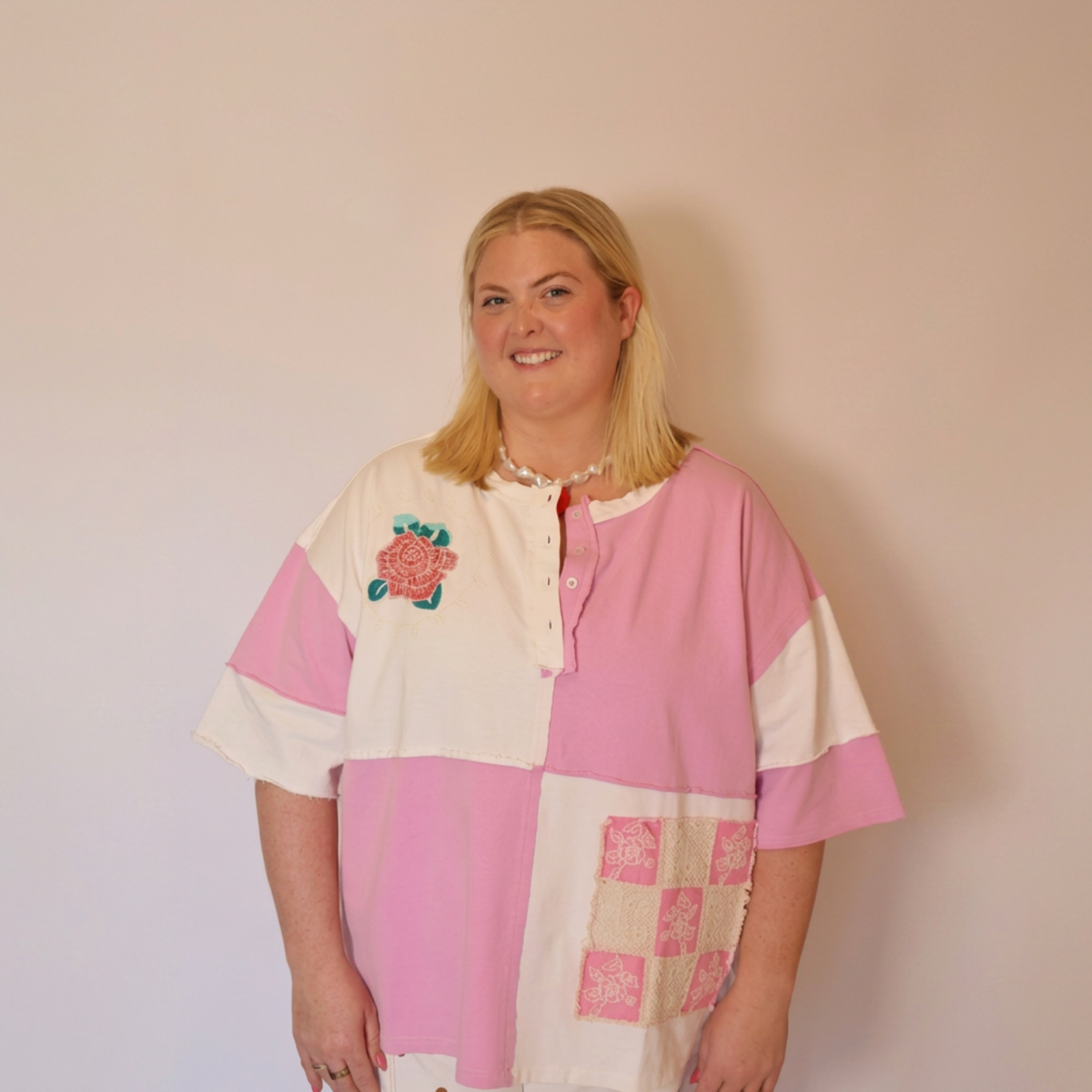 Image of the a woman wearing the Pippa tee facing forward. The image only shows from the waist up.